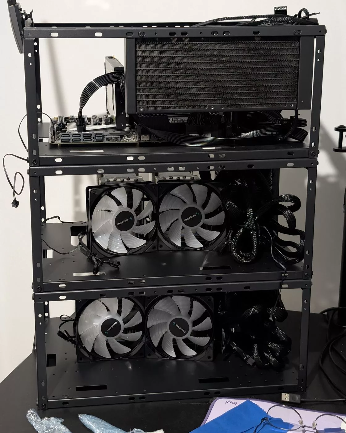 Three-tier frame with an AIO radiator on top and pairs of fans in front of each GPU tier
