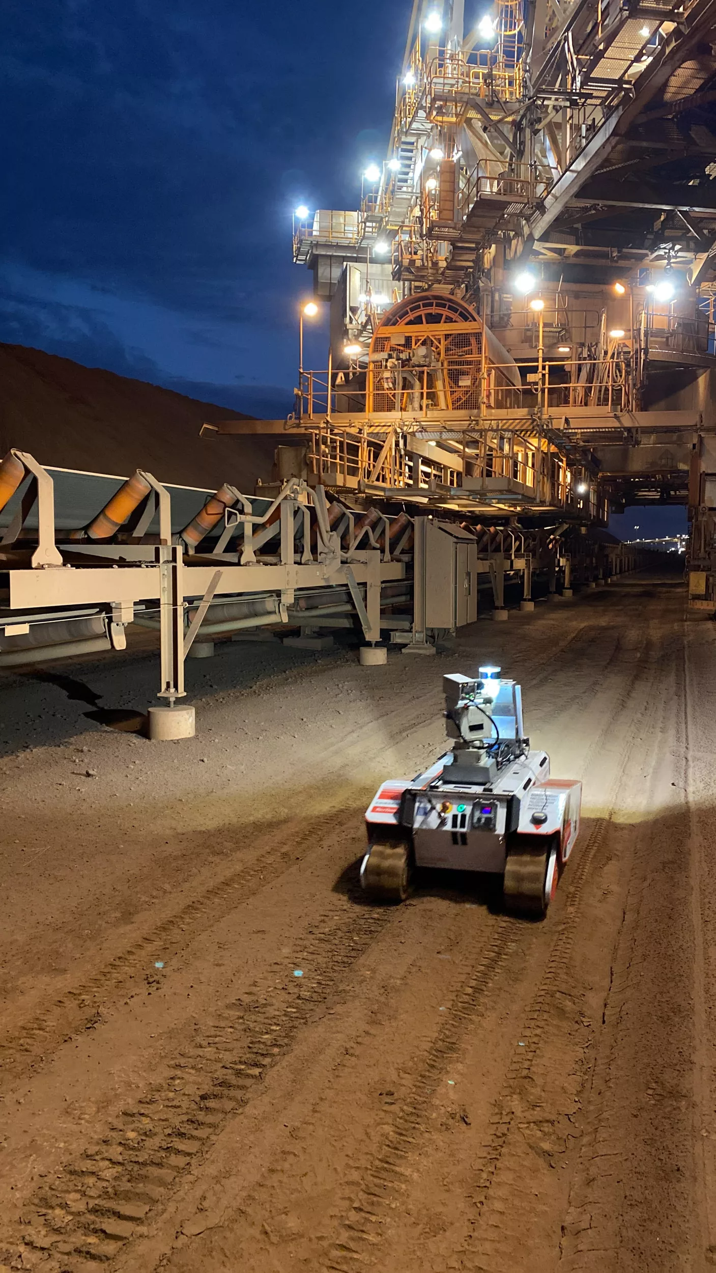 Autonomous inspection robot at a mine conveyor at night